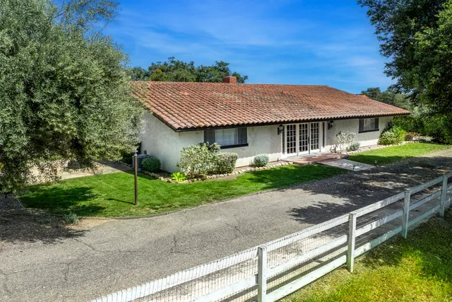 a front view of a house with a yard balcony