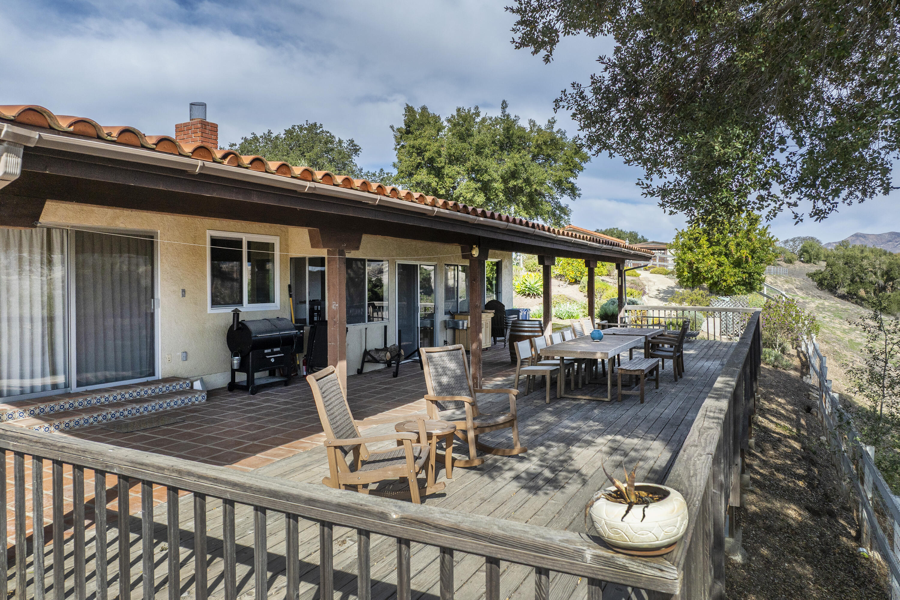 3776 Live Oak Road Santa Ynez, CA 93460 - Photo 6 of 36 a view of a patio with a dining table and chairs with wooden floor