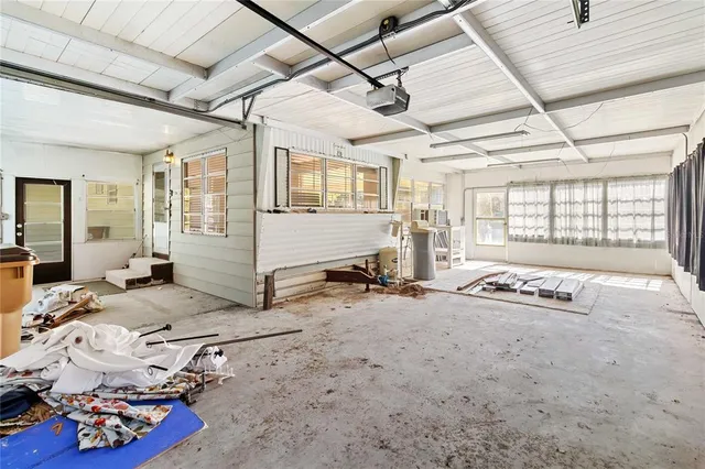 a spacious bedroom with a bed and a window