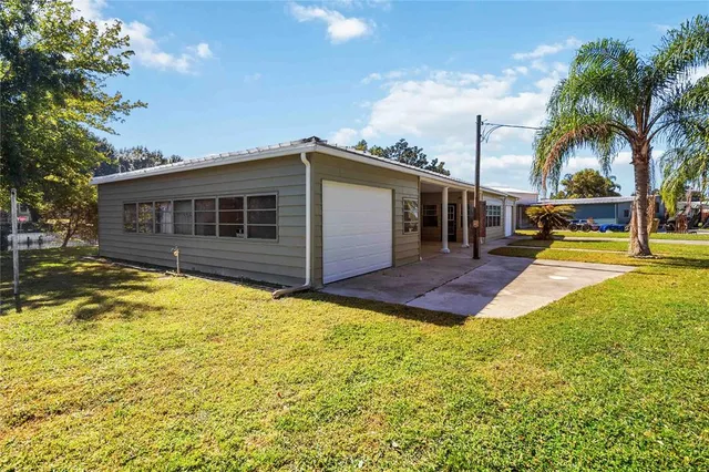 a swimming pool with outdoor seating and yard