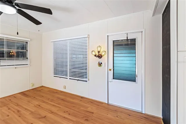 a view of a room with wooden floor and windows