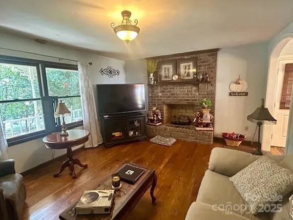 a living room with furniture flat screen tv and a fireplace