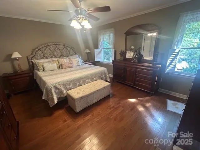 a bedroom with a bed window and dresser
