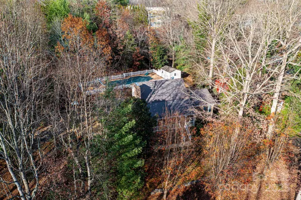 an aerial view of house with yard and mountain view in back