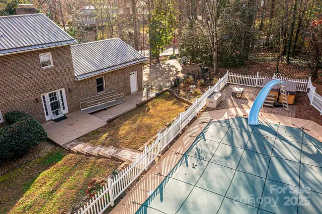 a view of a house with backyard and sitting area