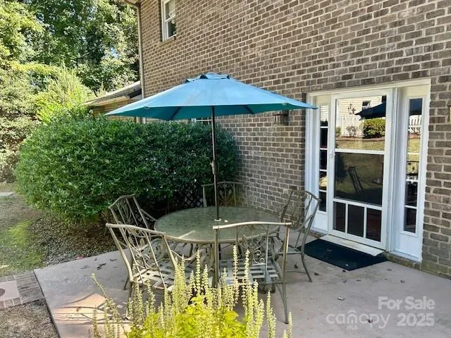 a patio with table and chairs