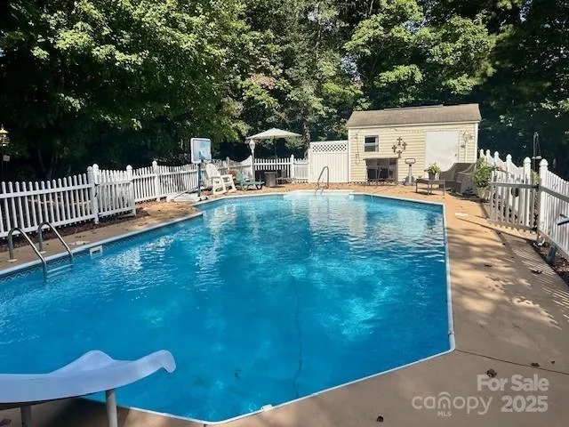 a backyard of a house with table and chairs
