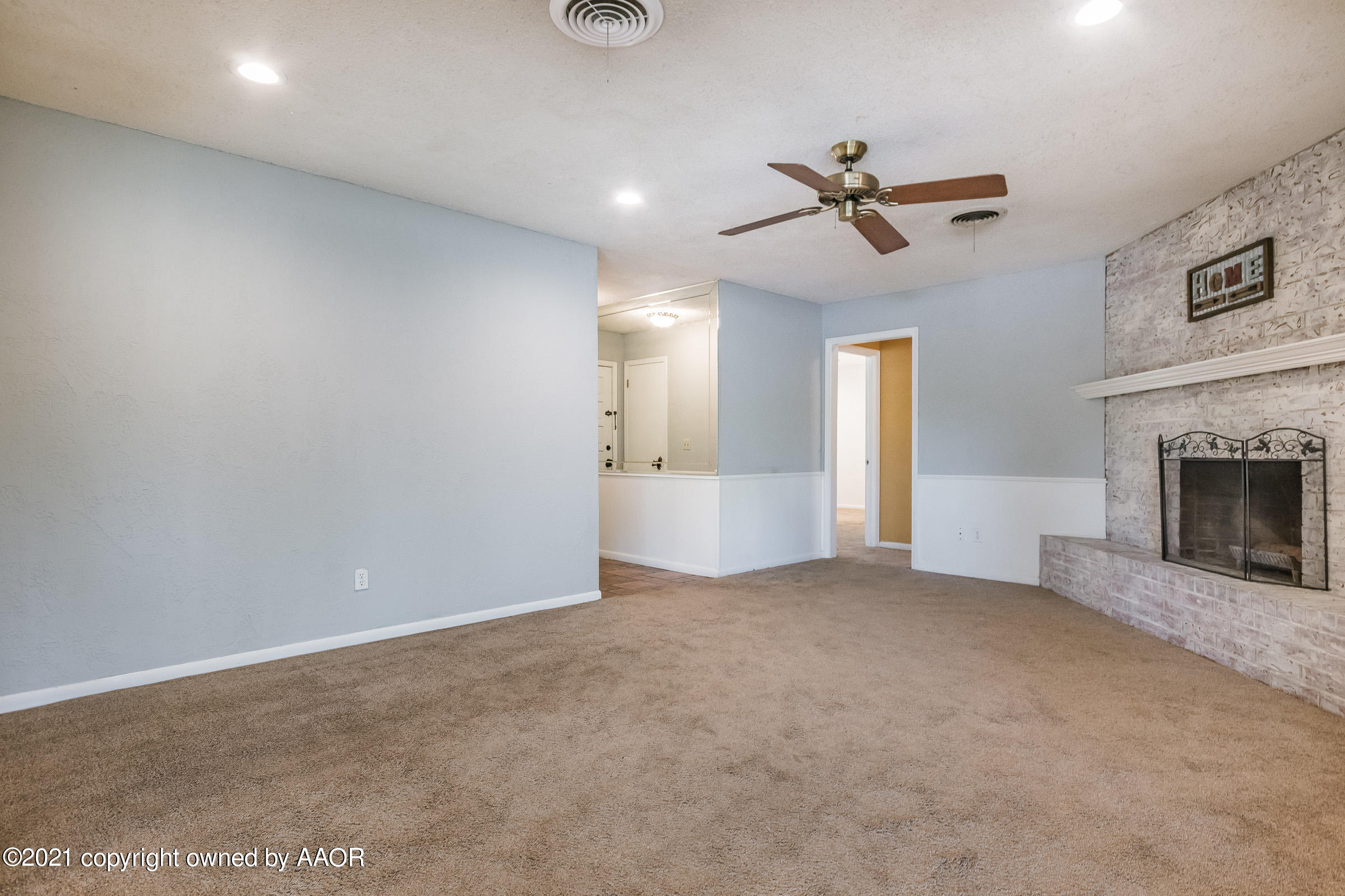 4222 Gary Lane Amarillo, TX 79110 - Photo 3 of 20 an empty room with windows and fireplace