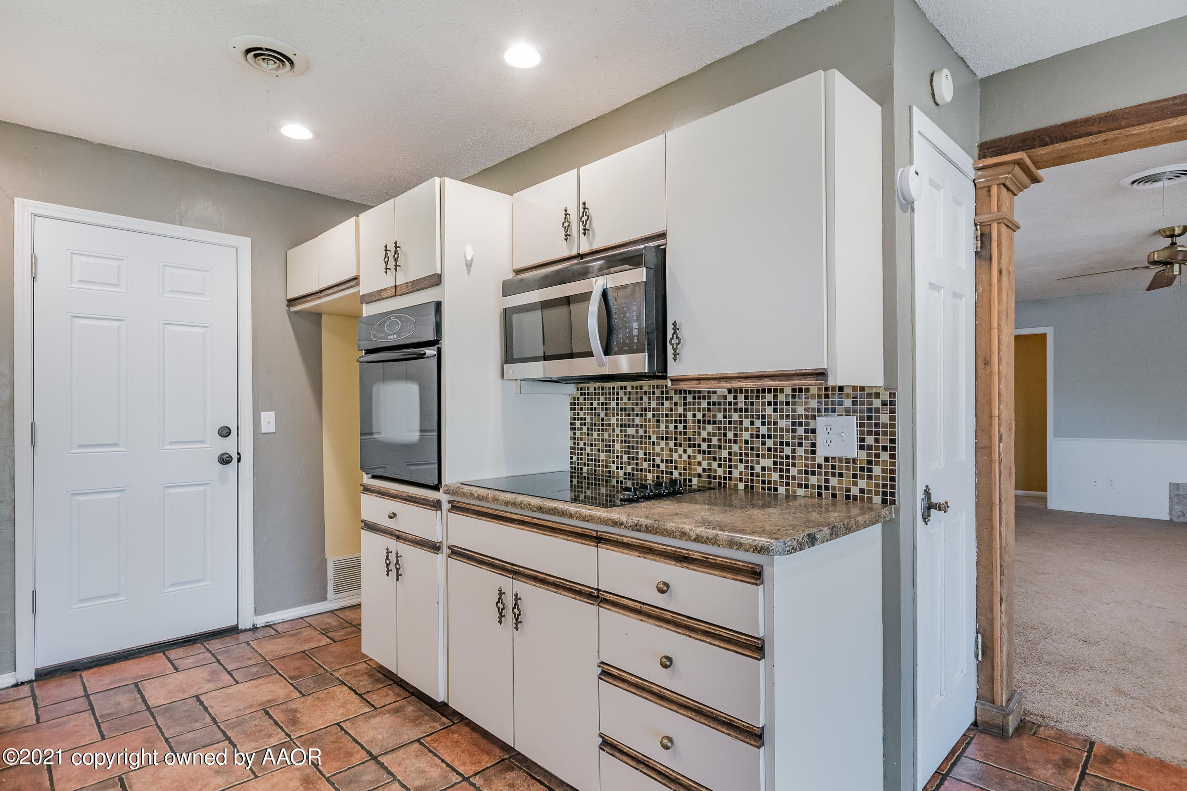 4222 Gary Lane Amarillo, TX 79110 - Photo 7 of 20 a kitchen with granite countertop white cabinets and stainless steel appliances