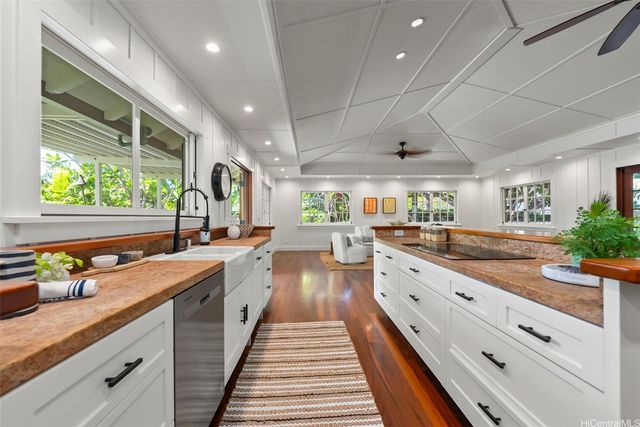 a room with wooden floor and potted plant