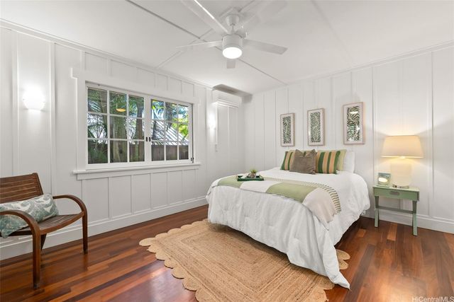 a bathroom with a granite countertop sink a toilet a mirror and shower