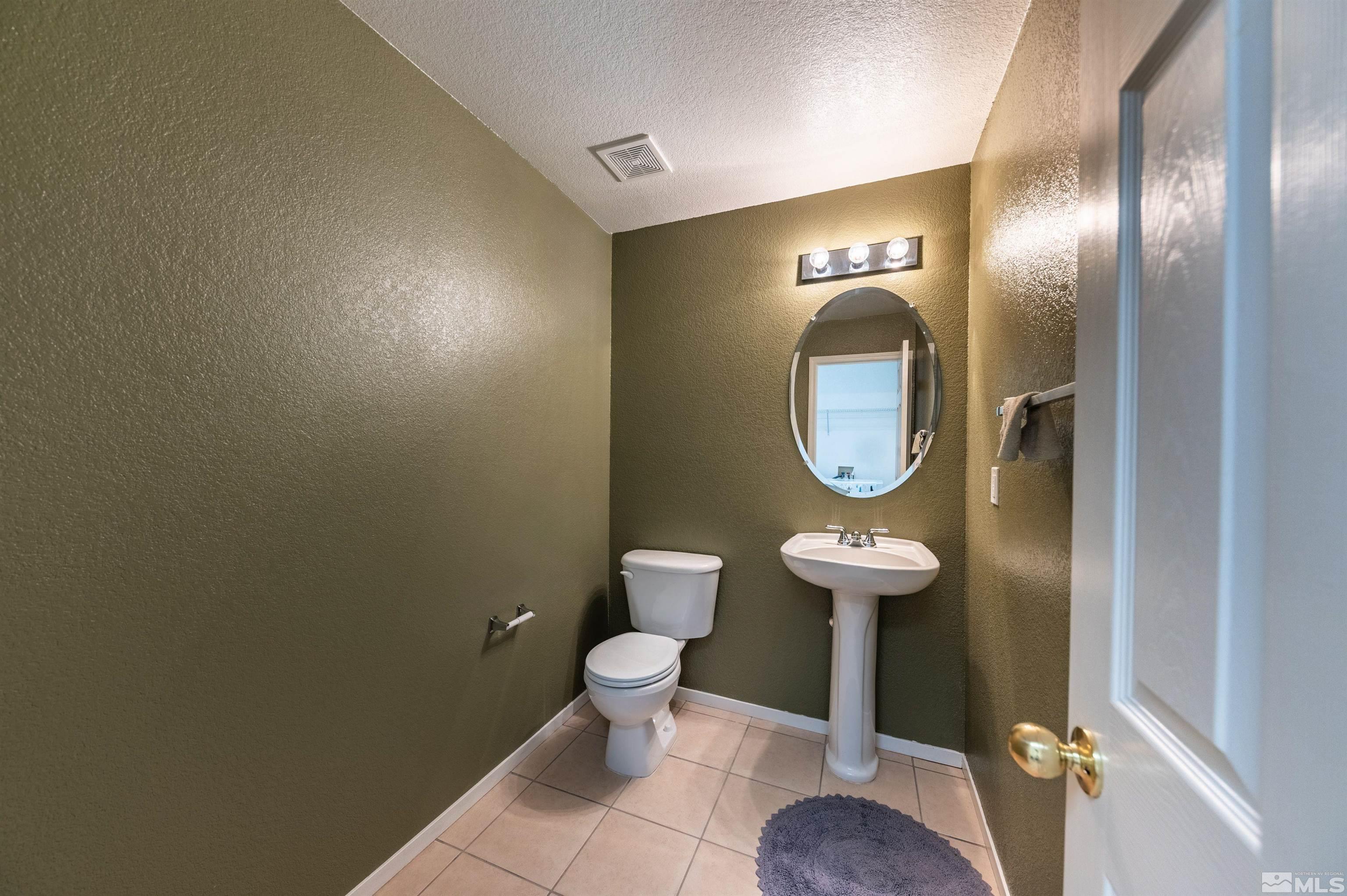 7830 Welsh Drive Reno, NV 89506 - Photo 18 of 27 a bathroom with a toilet and a mirror