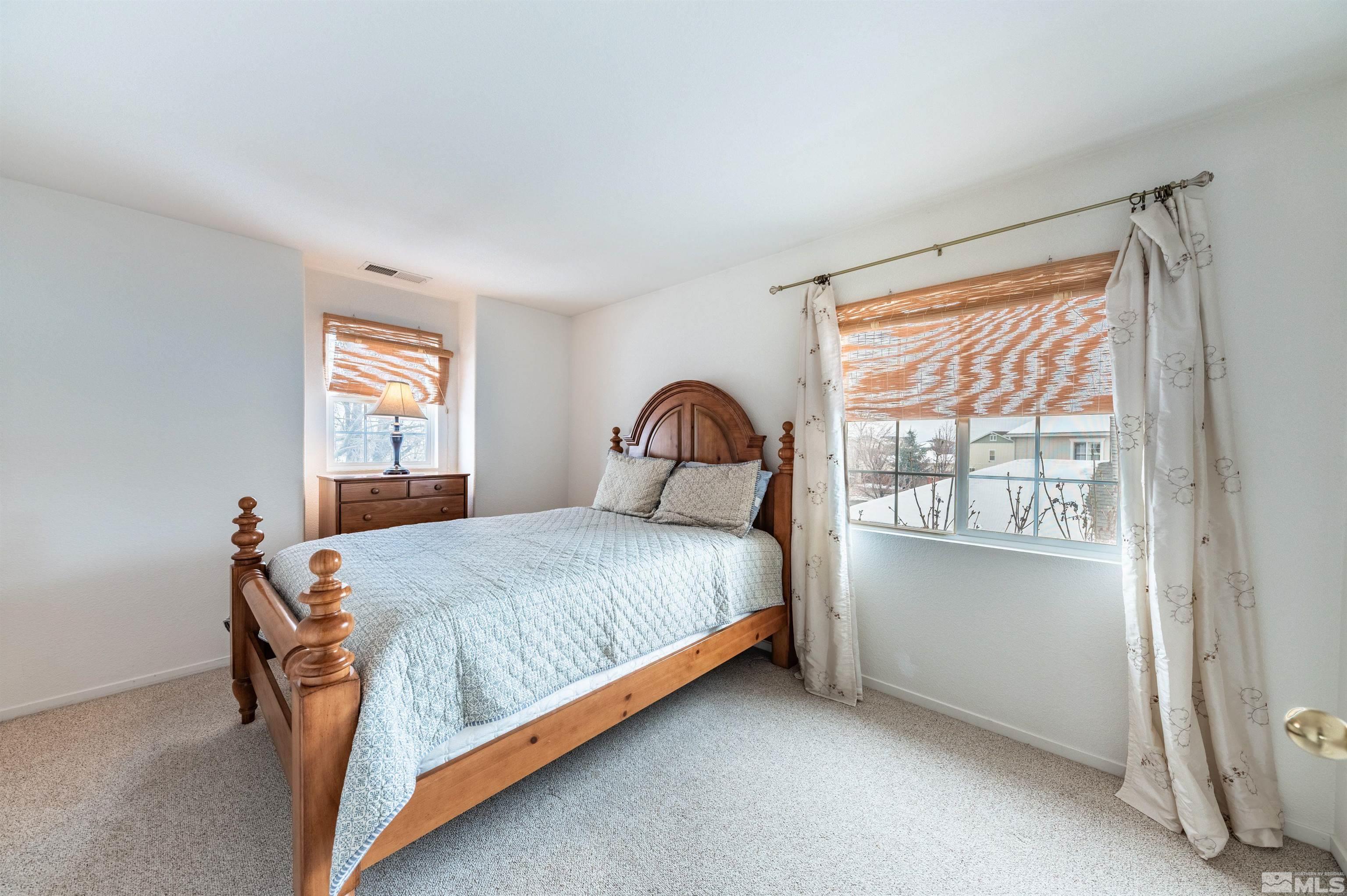 7830 Welsh Drive Reno, NV 89506 - Photo 24 of 27 a bedroom with a bed and window