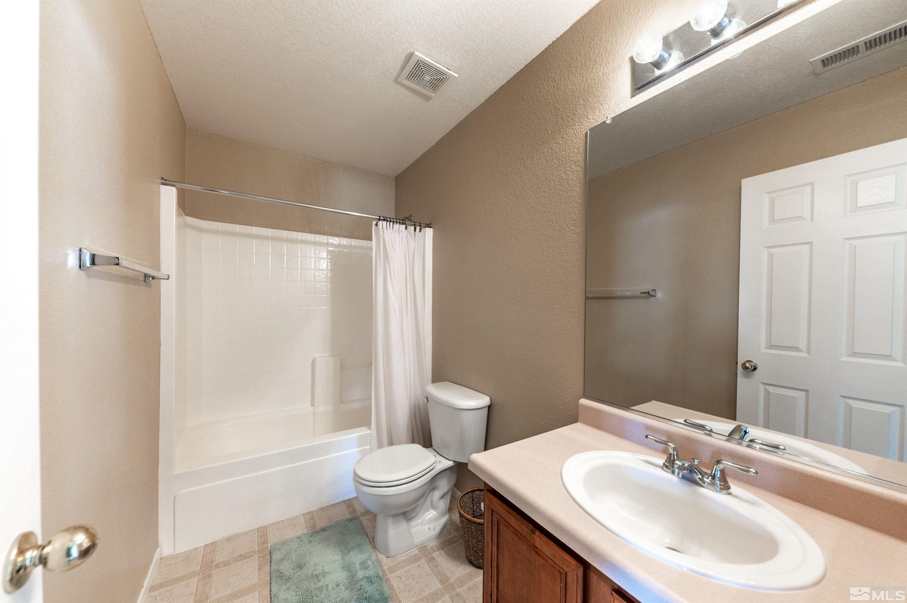7830 Welsh Drive Reno, NV 89506 - Photo 25 of 27 a bathroom with a sink a toilet and shower