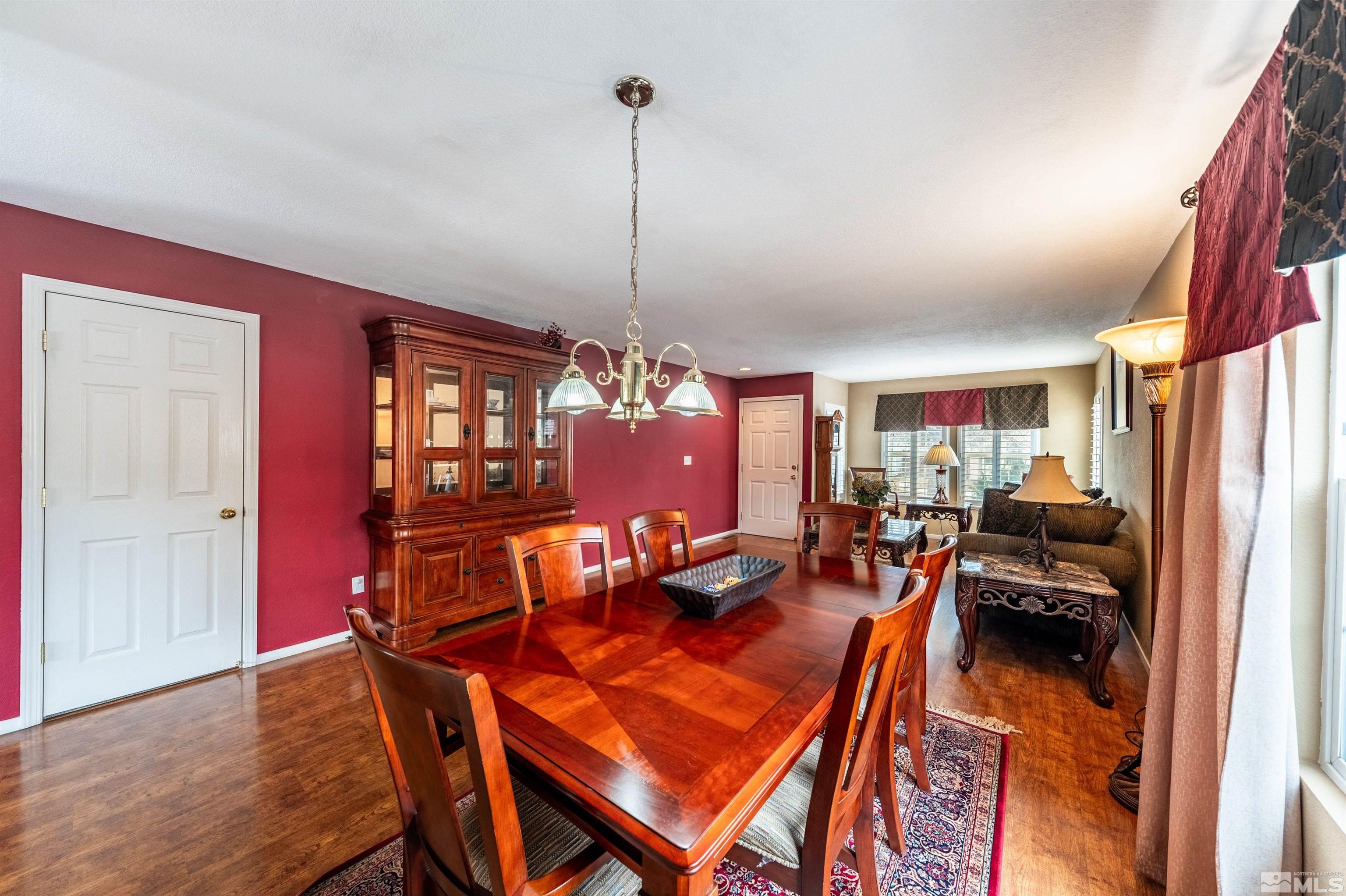 7830 Welsh Drive Reno, NV 89506 - Photo 8 of 27 a living room with furniture a dining table and chairs with wooden floor