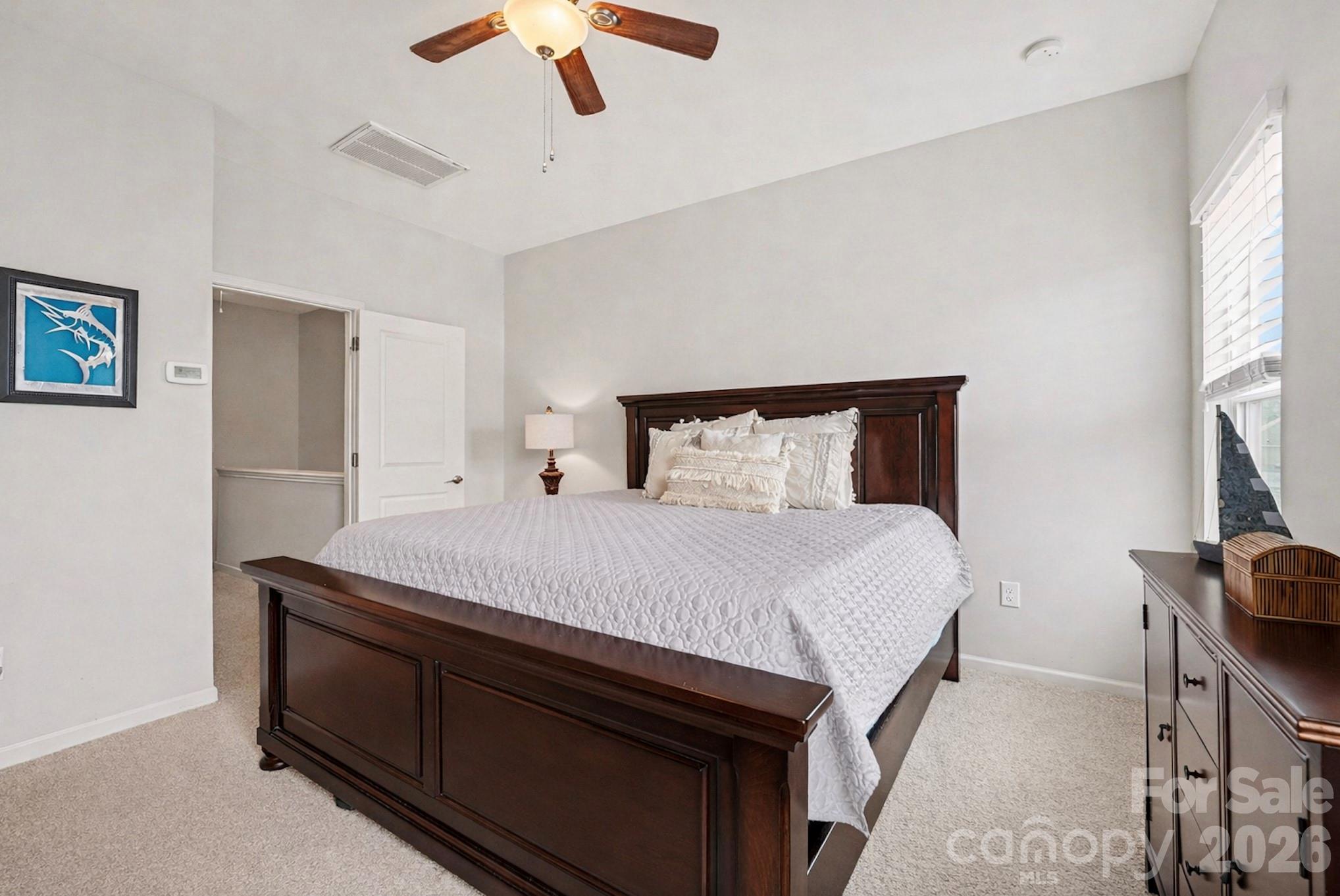 1225 Assembly Street Belmont, NC 28012 - Photo 15 of 17 a bedroom with a bed and a chandelier