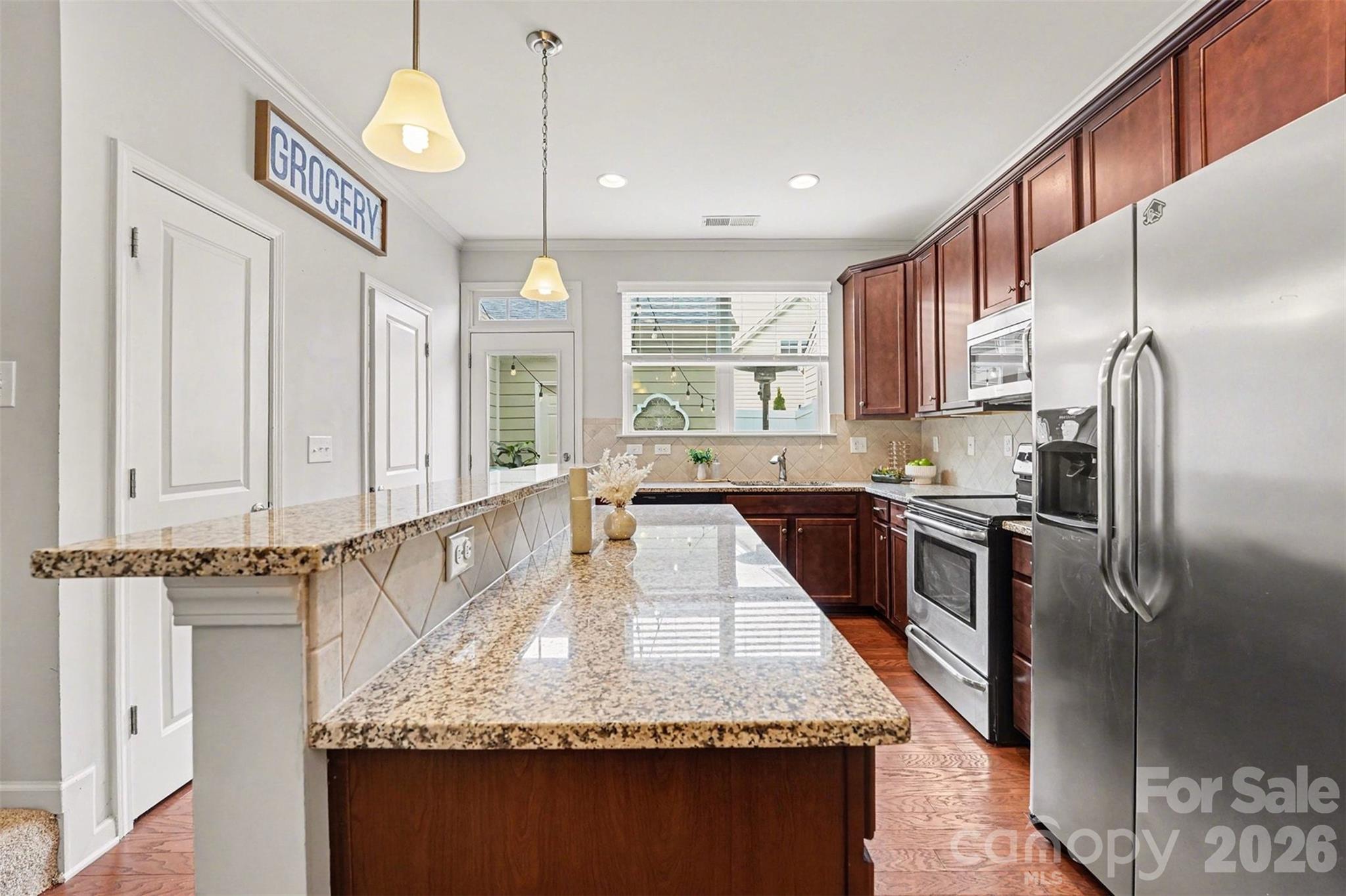 1225 Assembly Street Belmont, NC 28012 - Photo 6 of 17 a large kitchen with kitchen island granite countertop a large counter top appliances and cabinets