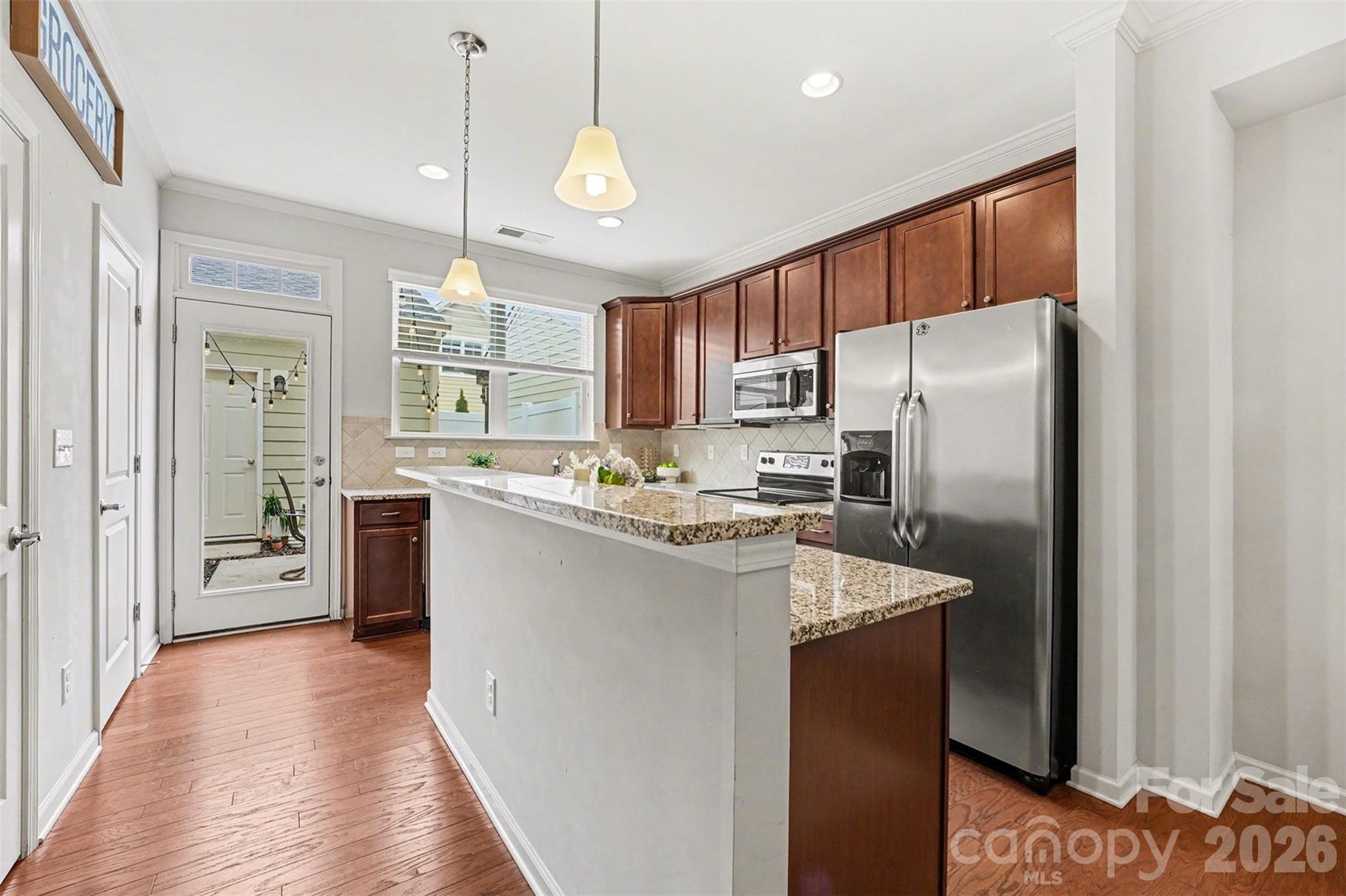 1225 Assembly Street Belmont, NC 28012 - Photo 7 of 17 a kitchen with refrigerator a sink and cabinets