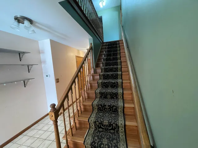 a bathroom with a granite countertop sink toilet and mirror