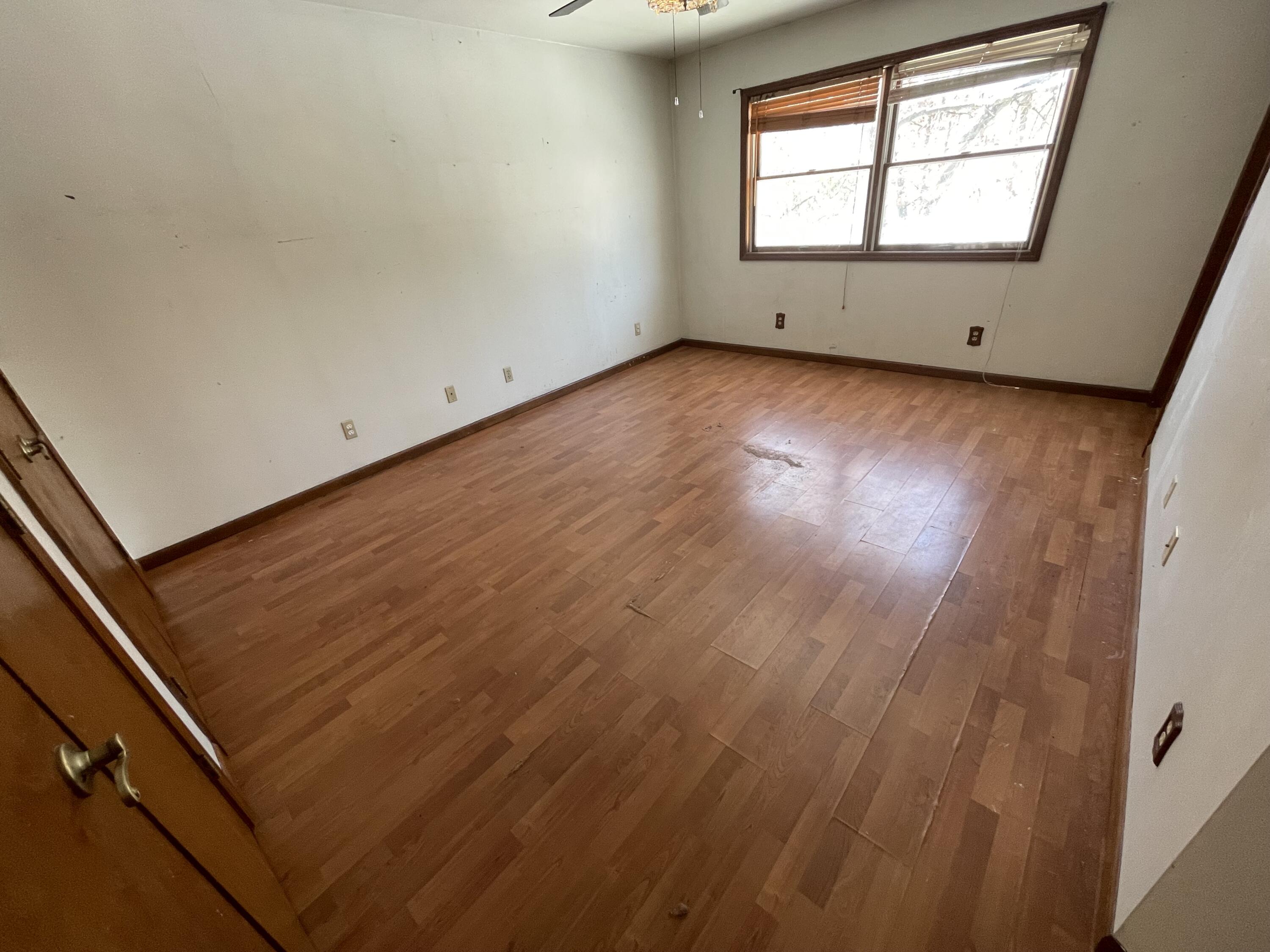 9710 Rustic Drive Demotte, IN 46310 - Photo 18 of 31 an empty room with wooden floor and windows
