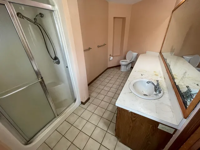 a view of a hallway with wooden floor and entryway