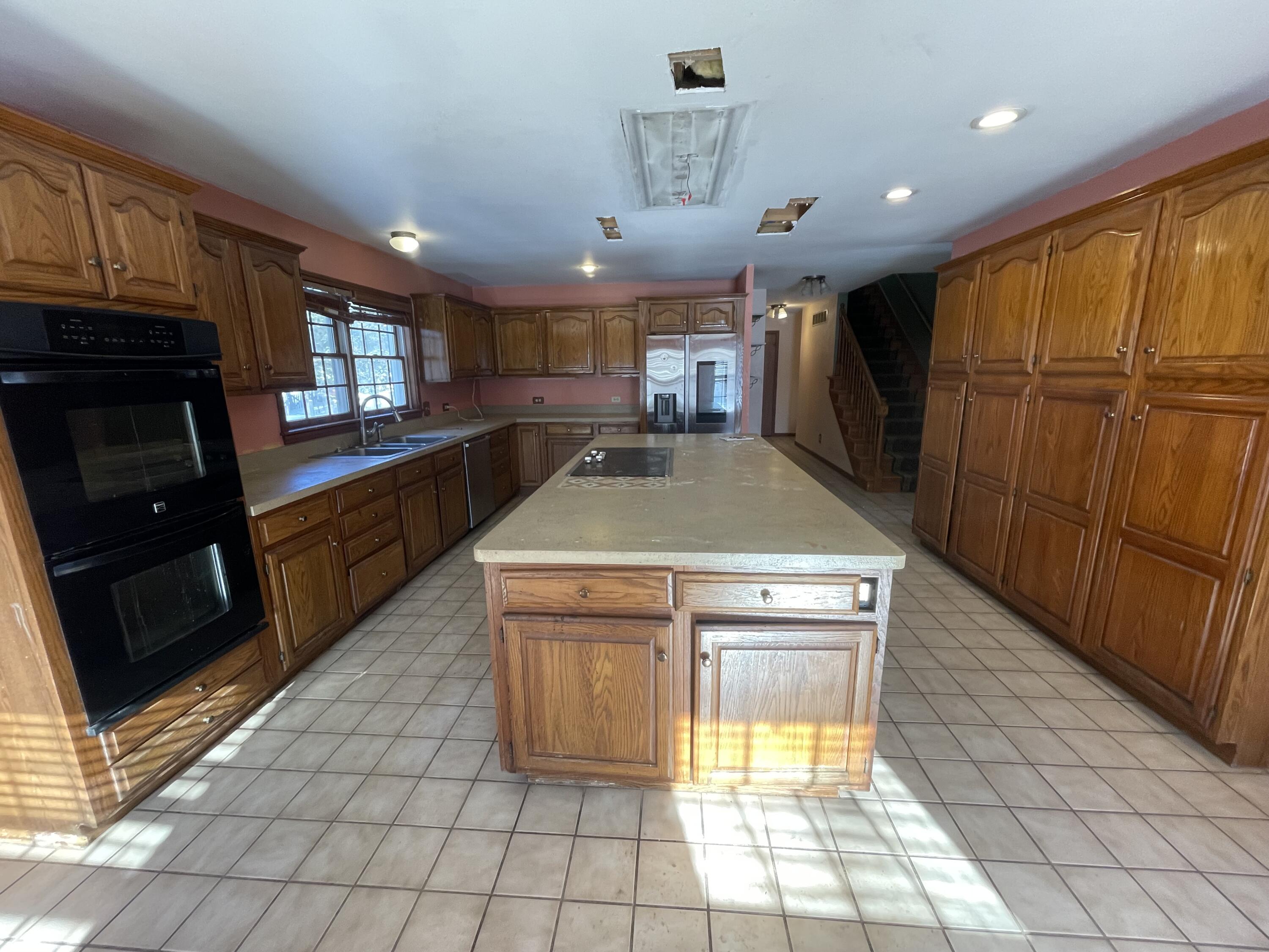9710 Rustic Drive Demotte, IN 46310 - Photo 7 of 31 a kitchen with stainless steel appliances granite countertop a stove a sink and a microwave
