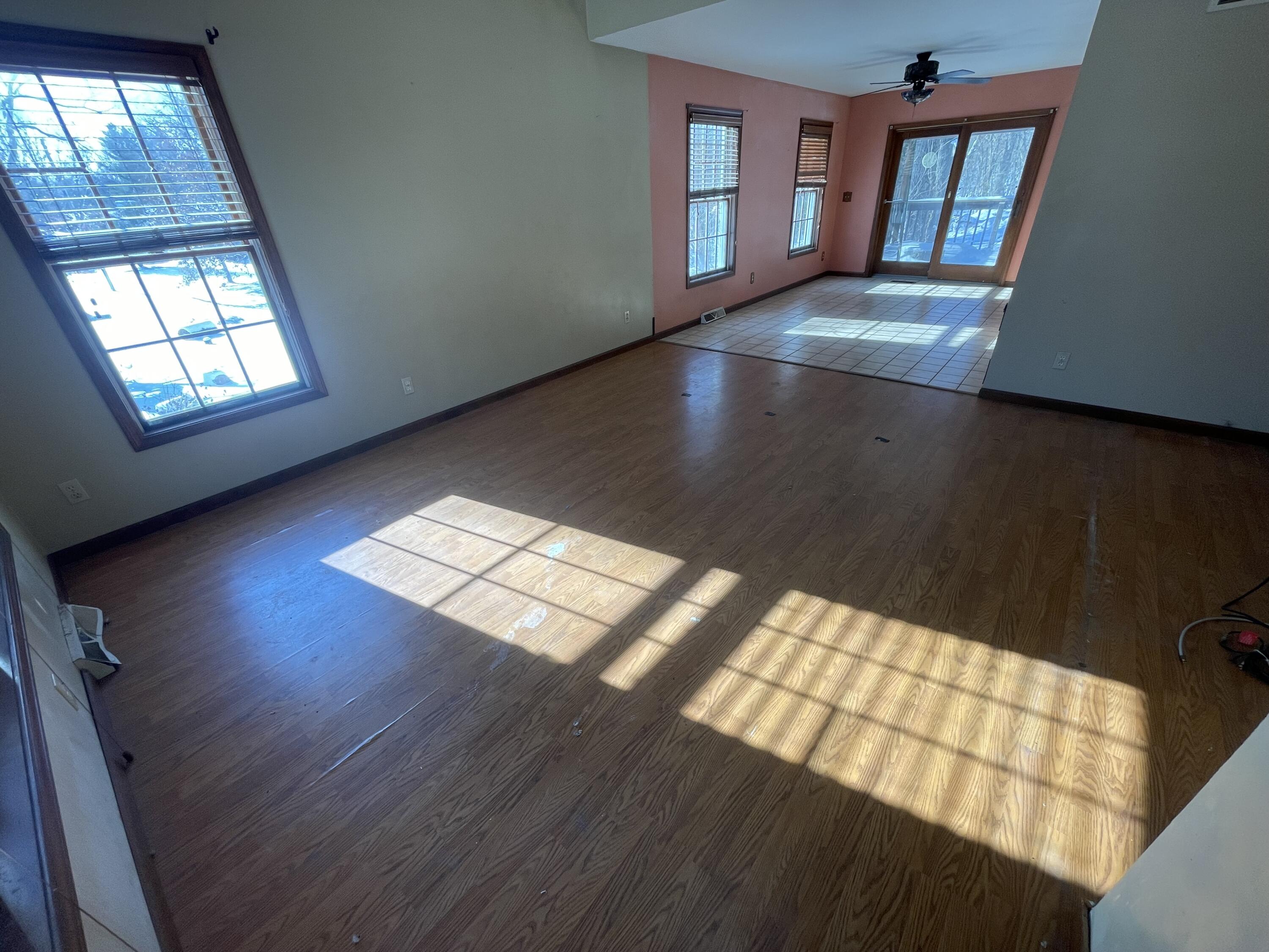 9710 Rustic Drive Demotte, IN 46310 - Photo 9 of 31 wooden floor in an empty room with a window