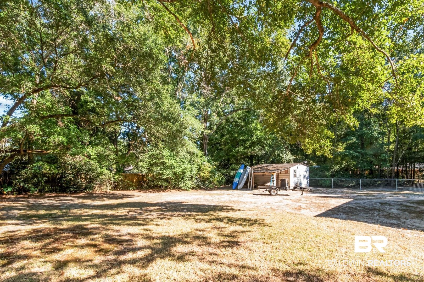 1321 Rainbow Drive West Mobile, AL 36693 - Photo 39 of 48 View of yard featuring a storage unit