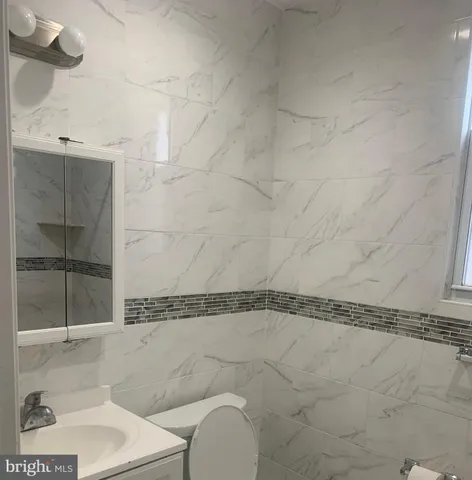 a bathroom with a window and a shower