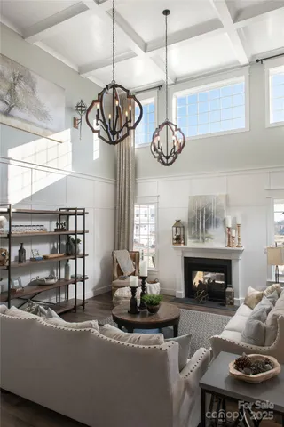 a living room with fireplace furniture and a chandelier