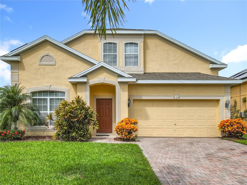 334 Cadiz Loop Davenport, FL 33837 - Photo 11 of 63 a front view of a house with a garden and plants