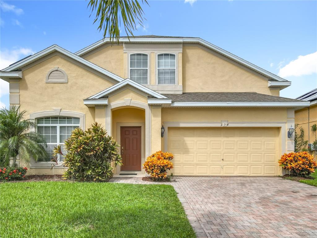 334 Cadiz Loop Davenport, FL 33837 - Photo 12 of 63 a front view of a house with a garden