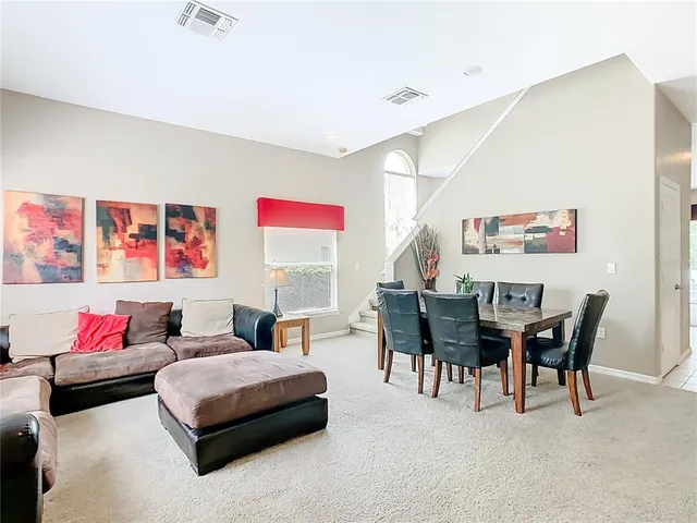 a view of a dining room with furniture and a chandelier