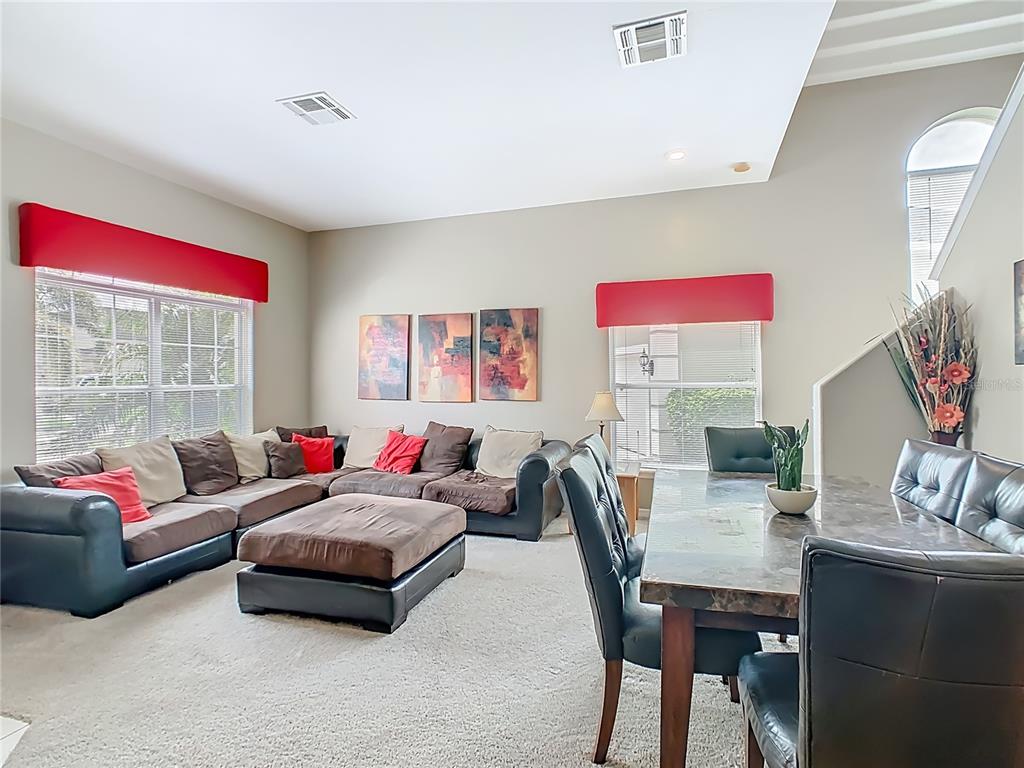 334 Cadiz Loop Davenport, FL 33837 - Photo 14 of 63 a living room with furniture and a flat screen tv