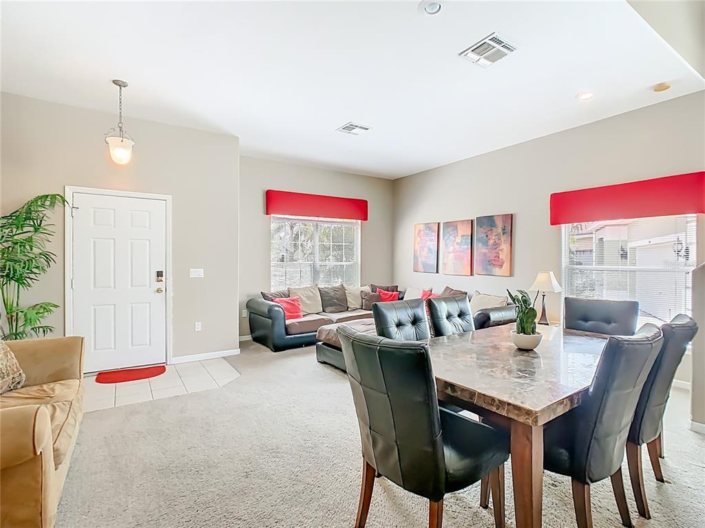 334 Cadiz Loop Davenport, FL 33837 - Photo 15 of 63 a view of a dining room with furniture and a chandelier