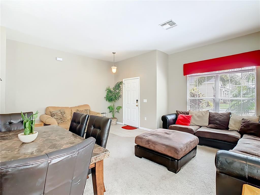 334 Cadiz Loop Davenport, FL 33837 - Photo 16 of 63 a living room with furniture and a table