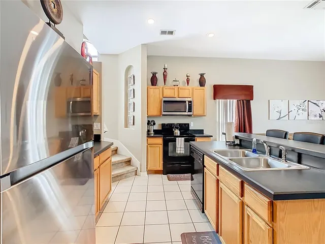 a living room with furniture and kitchen view