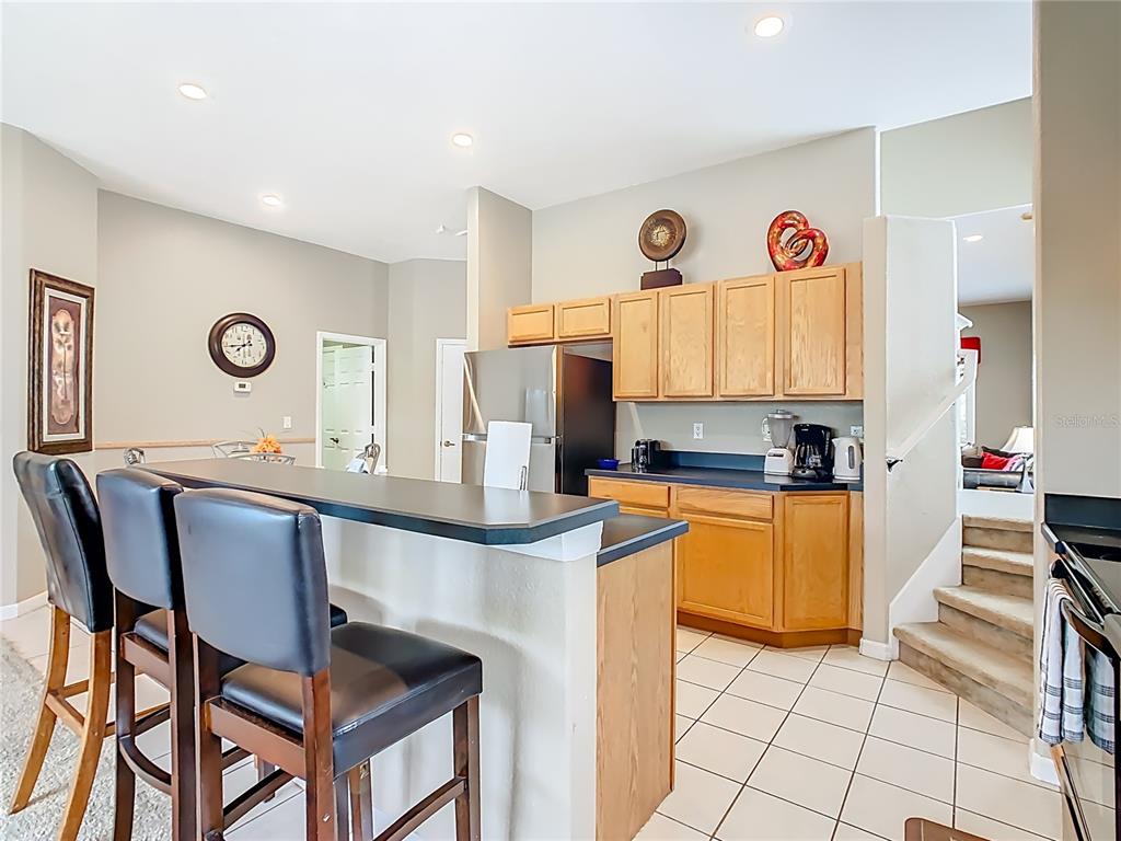 334 Cadiz Loop Davenport, FL 33837 - Photo 23 of 63 a kitchen with stainless steel appliances granite countertop a stove a sink and a refrigerator