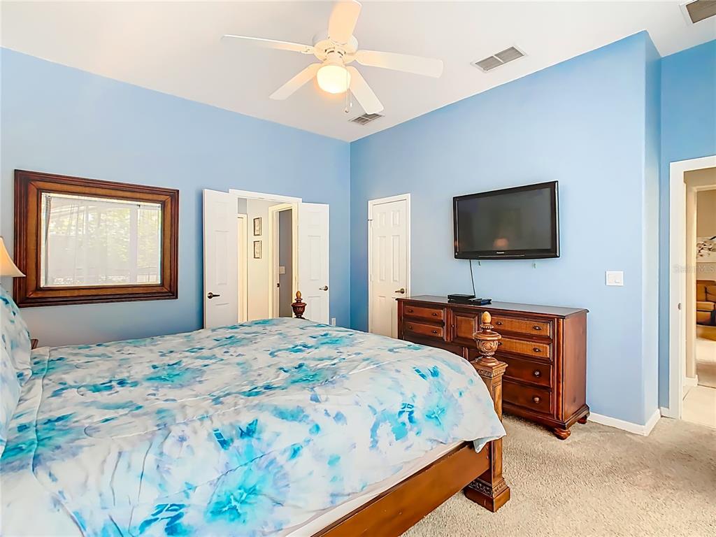 334 Cadiz Loop Davenport, FL 33837 - Photo 31 of 63 a bedroom with a bed and a flat screen tv