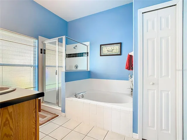 a bedroom with a bed and a television