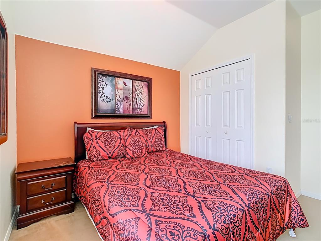 334 Cadiz Loop Davenport, FL 33837 - Photo 36 of 63 a bedroom with a bed and a painting on the wall