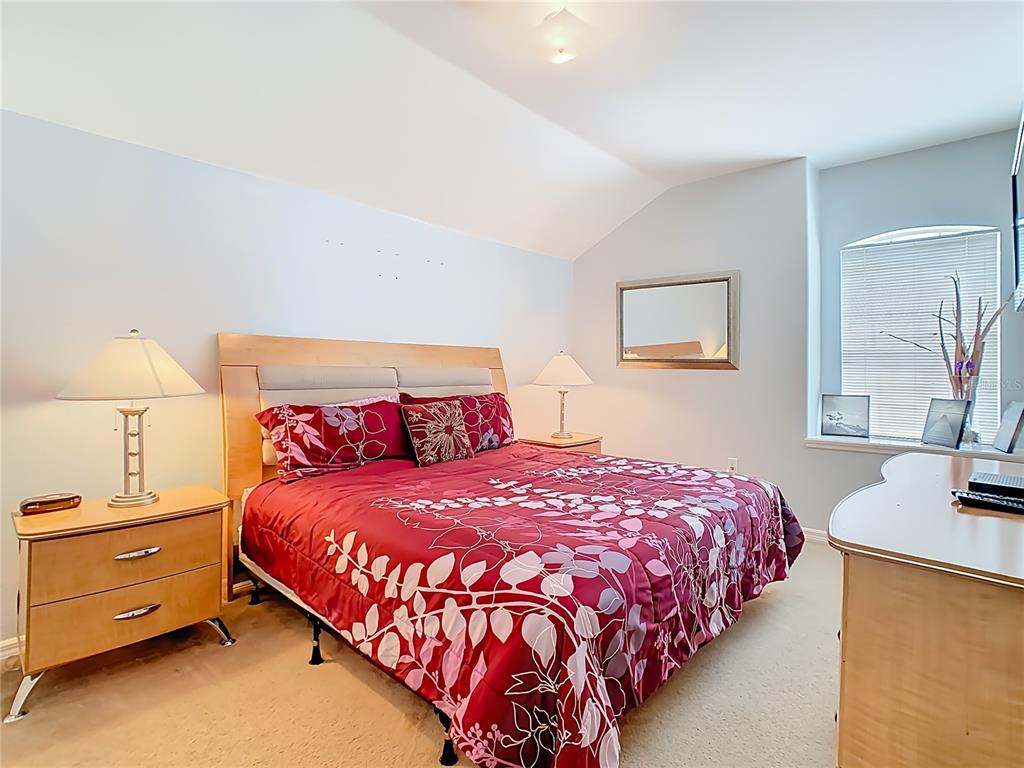 334 Cadiz Loop Davenport, FL 33837 - Photo 38 of 63 a bedroom with a bed and window