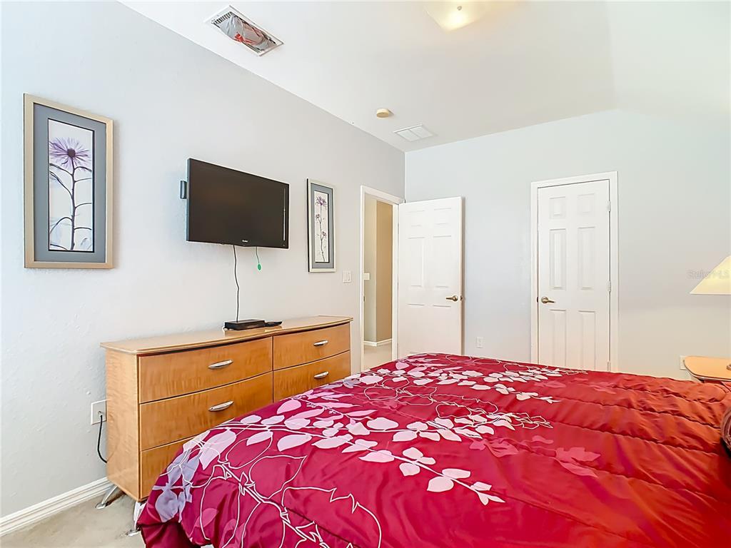 334 Cadiz Loop Davenport, FL 33837 - Photo 39 of 63 a bedroom with a bed and a flat screen tv