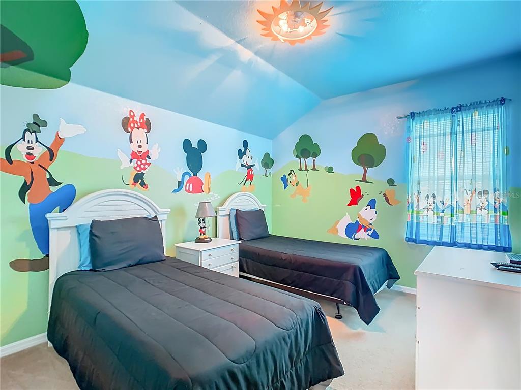 334 Cadiz Loop Davenport, FL 33837 - Photo 41 of 63 a bedroom with two beds and a table