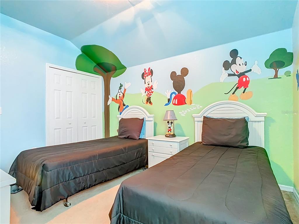 334 Cadiz Loop Davenport, FL 33837 - Photo 42 of 63 a bedroom with two beds and a white wall