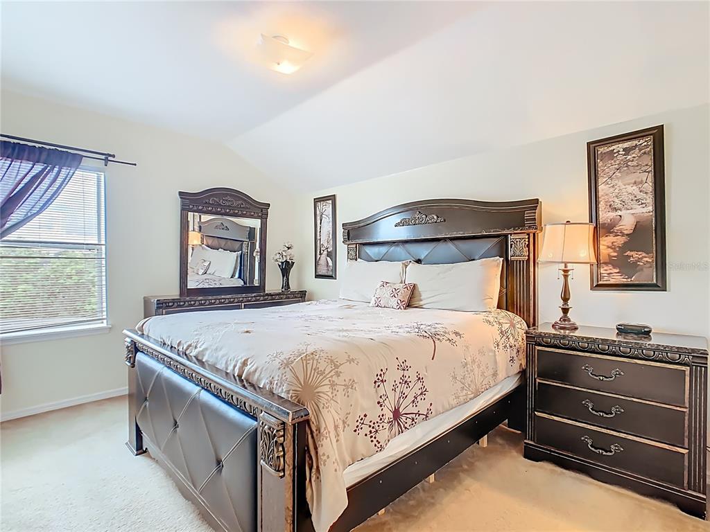 334 Cadiz Loop Davenport, FL 33837 - Photo 44 of 63 a bedroom with a bed and a window