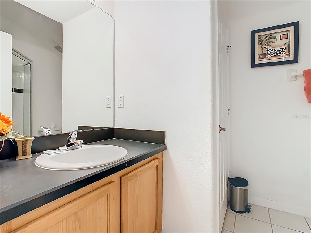 334 Cadiz Loop Davenport, FL 33837 - Photo 46 of 63 a bathroom with a sink and a mirror