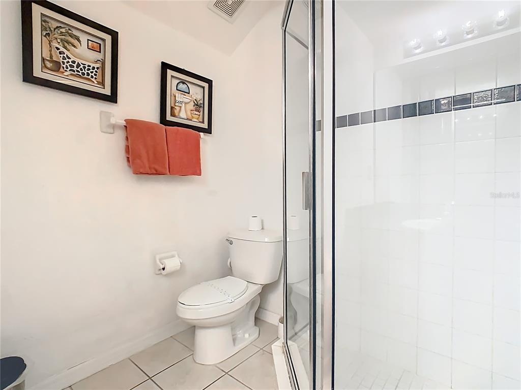 334 Cadiz Loop Davenport, FL 33837 - Photo 47 of 63 a bathroom with a toilet and a shower