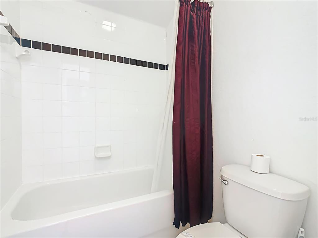 334 Cadiz Loop Davenport, FL 33837 - Photo 49 of 63 a bathroom with a bathtub and a shower