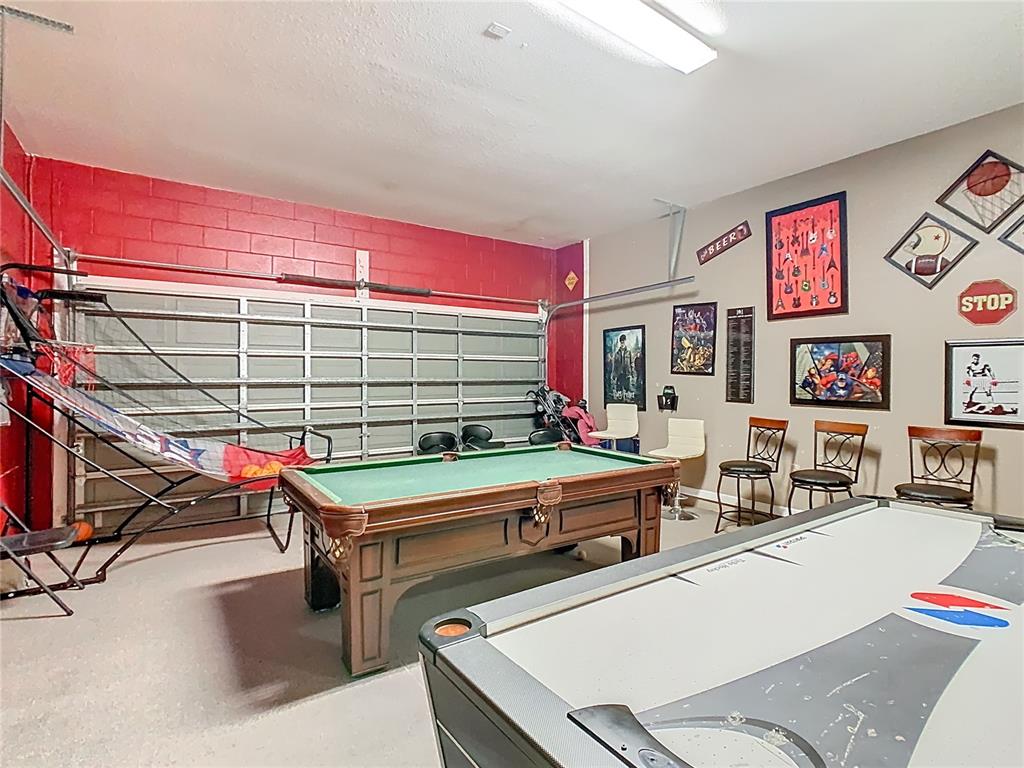 334 Cadiz Loop Davenport, FL 33837 - Photo 52 of 63 a room with pool table and windows